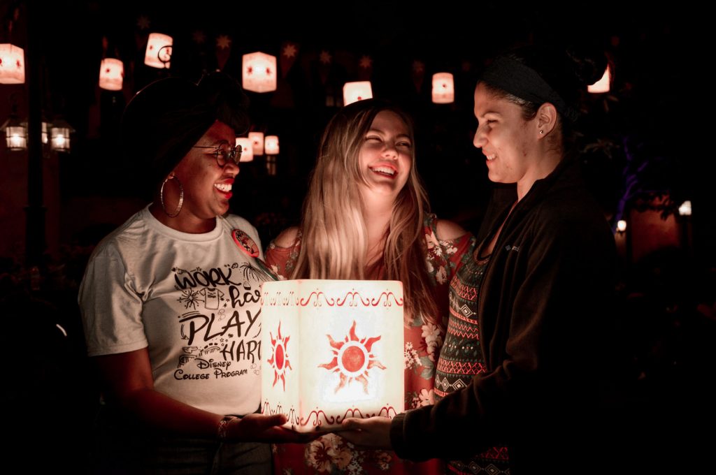 Three women posing with a lantern at Disney World